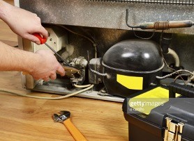 Technician works on refrigerator